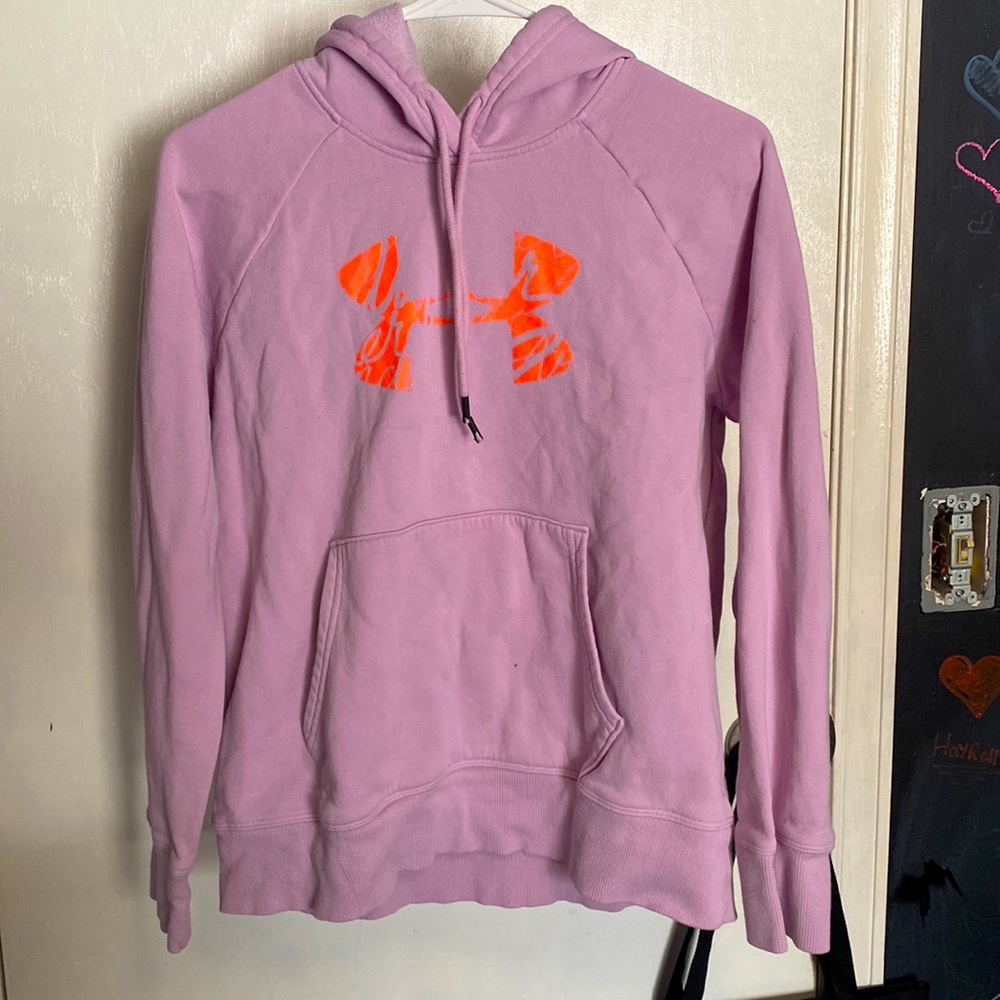 Light pink sweatshirt with bright orange logo.